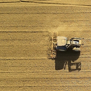 Top view of a tractor harvesting wheat.